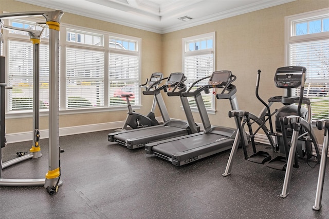 gym with baseboards, visible vents, and crown molding