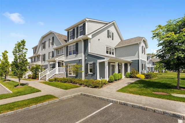 view of front facade featuring uncovered parking and a front lawn