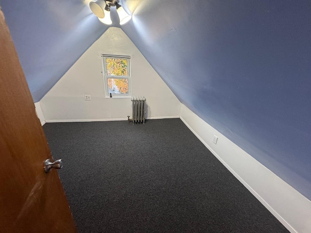 bonus room with carpet floors, lofted ceiling, radiator heating unit, ceiling fan, and baseboards