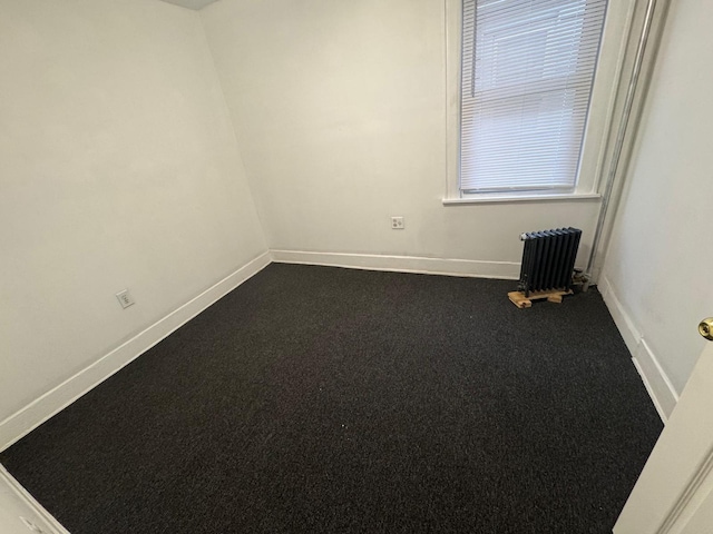 carpeted empty room with baseboards