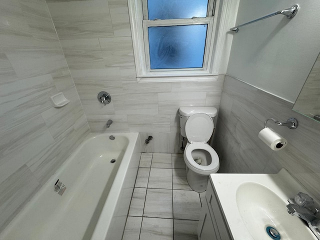 full bathroom featuring bathing tub / shower combination, vanity, toilet, and tile walls