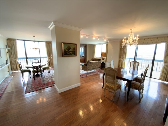 dining area with ornamental molding and a notable chandelier