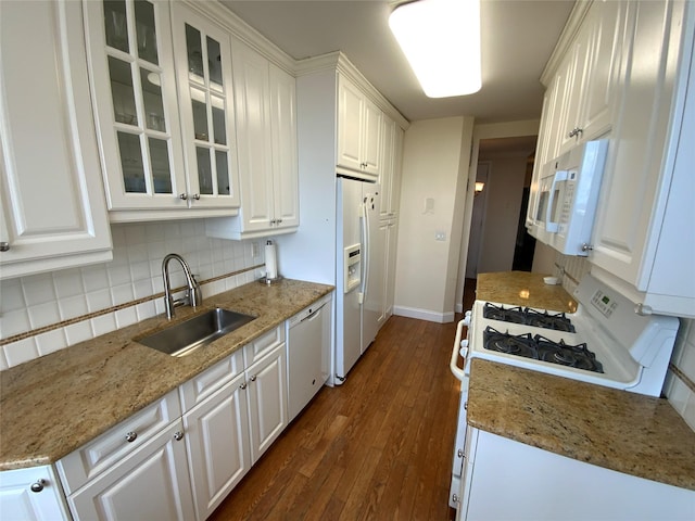 kitchen featuring white appliances, dark wood-style flooring, a sink, white cabinetry, and tasteful backsplash