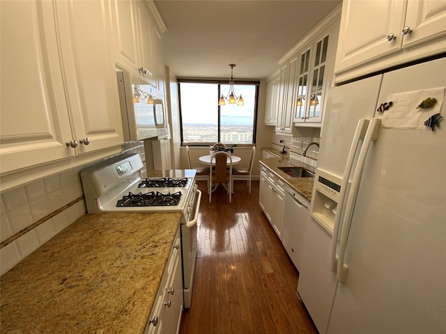 kitchen with white appliances, tasteful backsplash, dark wood finished floors, white cabinetry, and a sink