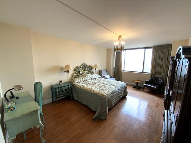 bedroom featuring baseboards, a chandelier, and hardwood / wood-style floors