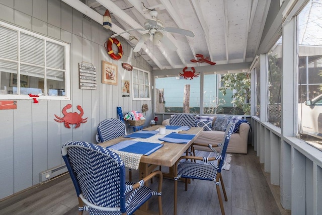 sunroom / solarium featuring lofted ceiling with beams, ceiling fan, and a wealth of natural light