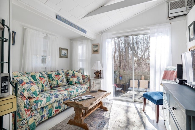 living room featuring lofted ceiling and a wall mounted AC