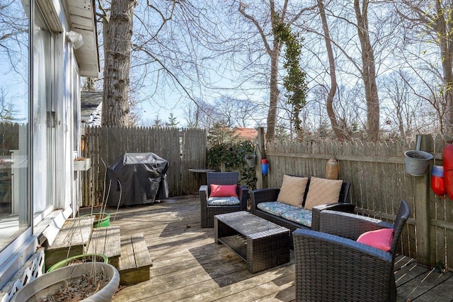 deck featuring fence private yard, a grill, and an outdoor hangout area