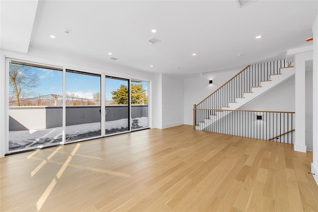 unfurnished room featuring recessed lighting, visible vents, light wood-style flooring, and baseboards