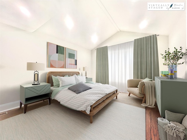 bedroom with visible vents, vaulted ceiling, and baseboards