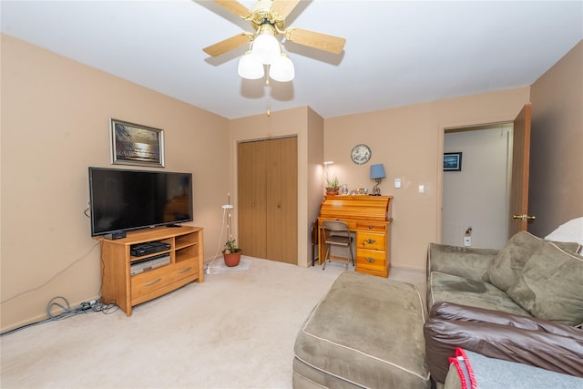 carpeted living area featuring a ceiling fan