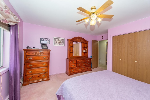 bedroom featuring a ceiling fan, a closet, and carpet flooring