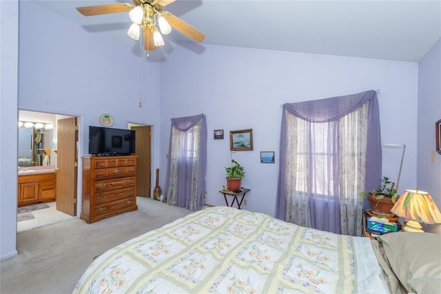 bedroom with carpet floors, ceiling fan, high vaulted ceiling, and connected bathroom