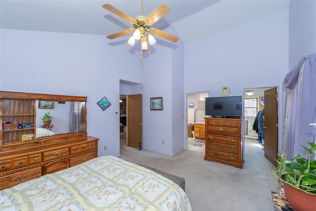 bedroom featuring light colored carpet, ceiling fan, ensuite bathroom, baseboard heating, and high vaulted ceiling