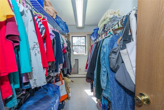 spacious closet featuring carpet floors and beamed ceiling