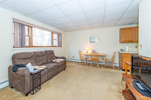 living room with light carpet, a drop ceiling, and baseboard heating