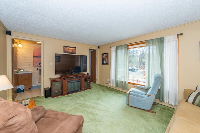 living area with a textured ceiling, carpet, and a glass covered fireplace