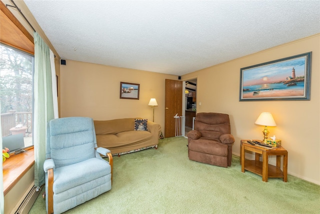 carpeted living area with baseboard heating and a textured ceiling