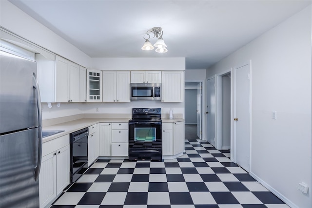 kitchen featuring white cabinets, black appliances, dark floors, and light countertops