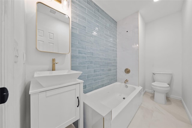 bathroom with baseboards, vanity, and toilet