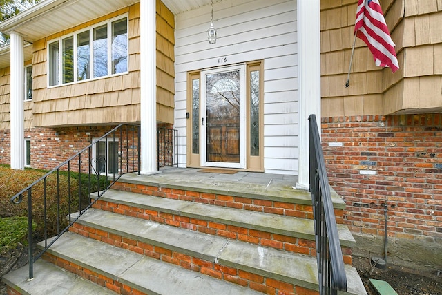 property entrance featuring brick siding