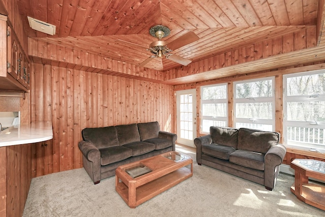 carpeted living area featuring wooden walls, wood ceiling, and ceiling fan