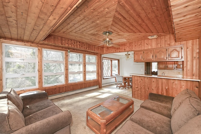 living room featuring light carpet, baseboard heating, wooden ceiling, and wood walls