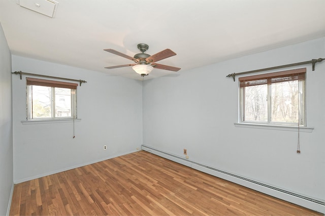 unfurnished room with ceiling fan, light wood finished floors, and a baseboard radiator