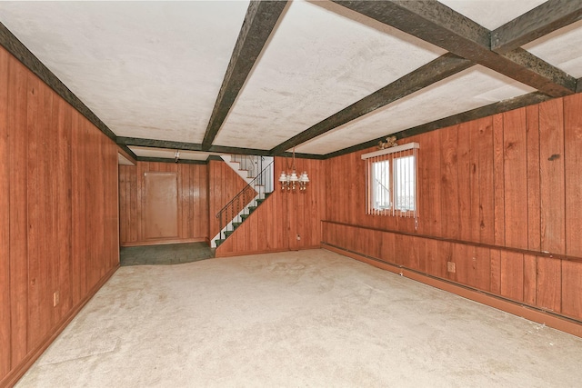 below grade area with stairway, light colored carpet, and wooden walls