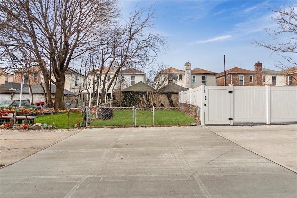 exterior space with a residential view and a gate