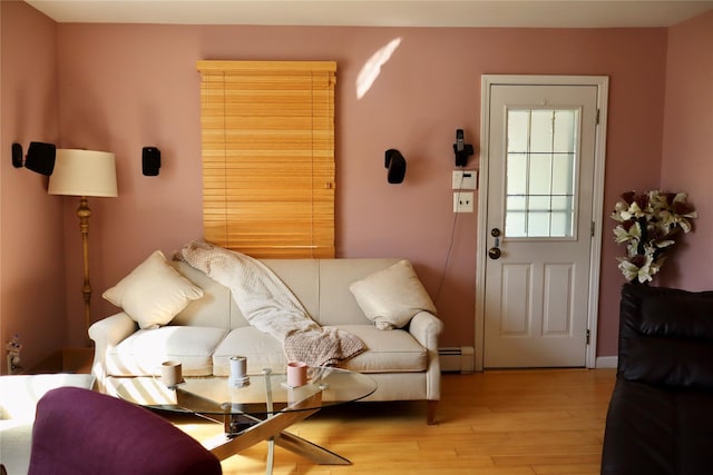 living area featuring light wood-style floors and baseboard heating