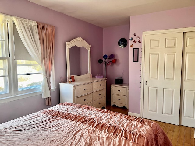 bedroom with a closet and wood finished floors