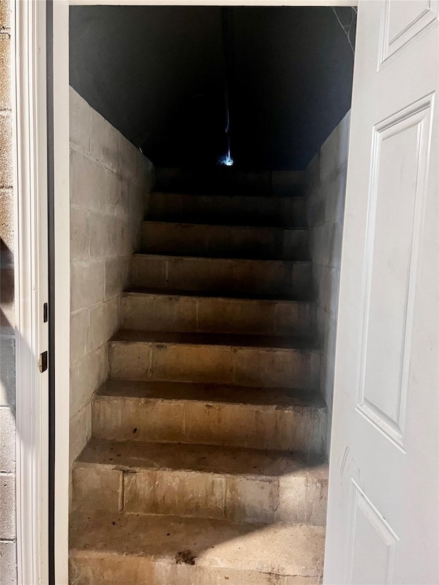 stairs with concrete block wall