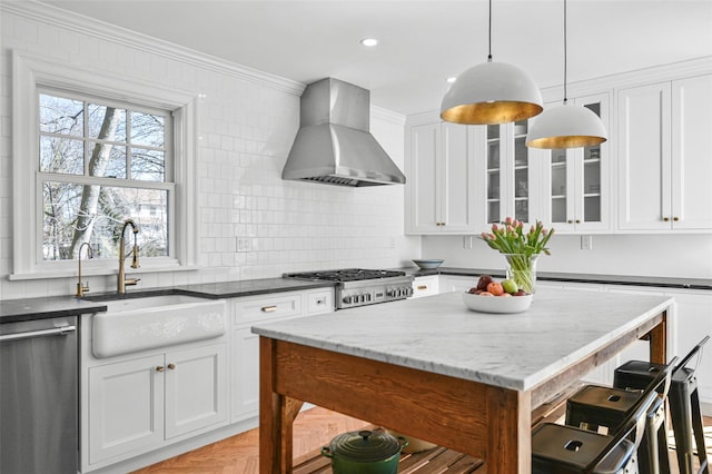 kitchen featuring crown molding, wall chimney range hood, dishwasher, stove, and a sink