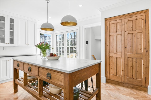 kitchen featuring recessed lighting, glass insert cabinets, pendant lighting, white cabinetry, and crown molding