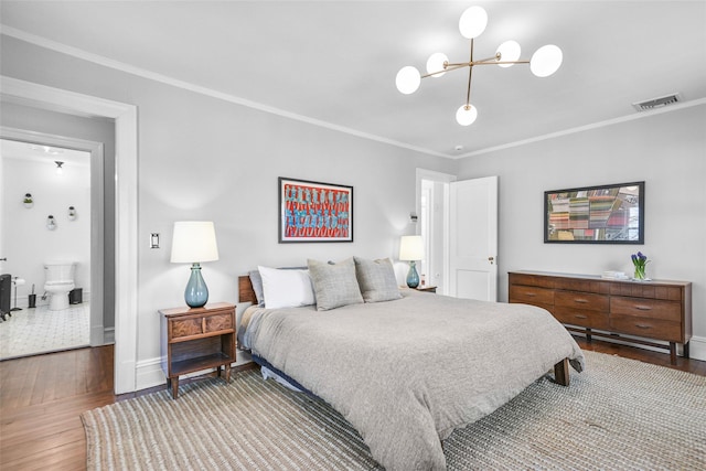 bedroom with visible vents, wood finished floors, and crown molding