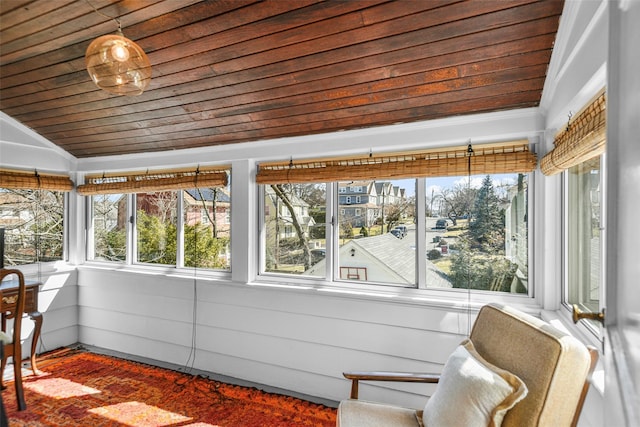 sunroom with vaulted ceiling and wood ceiling