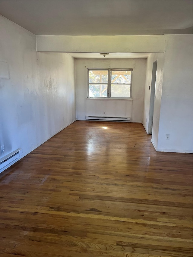 unfurnished room featuring a baseboard radiator and wood finished floors