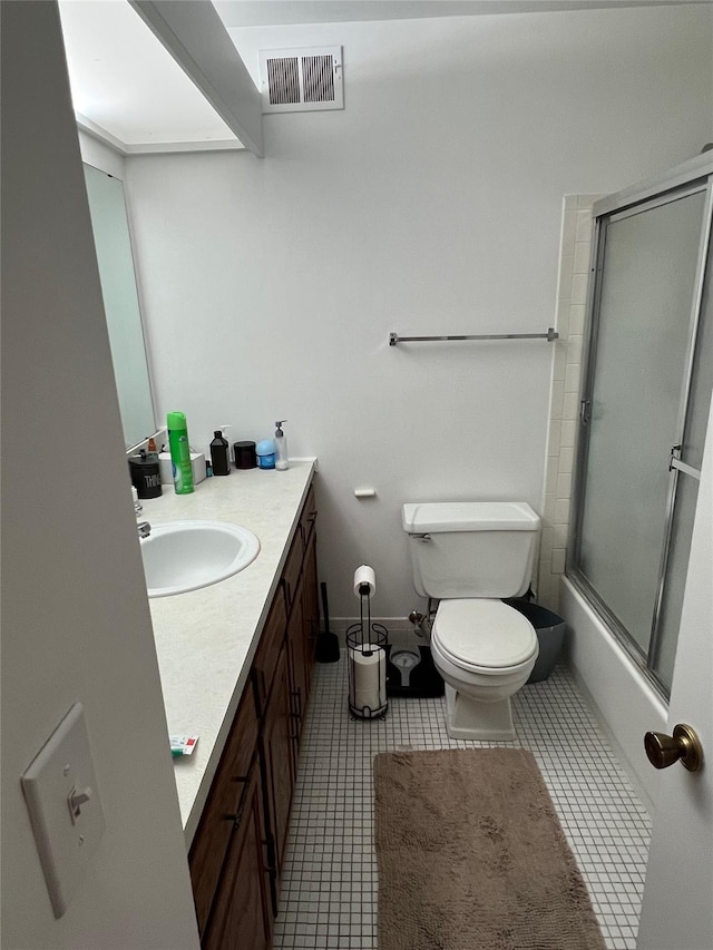 full bath featuring tile patterned floors, visible vents, toilet, bath / shower combo with glass door, and vanity