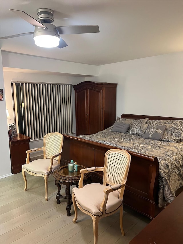 bedroom featuring light wood finished floors and a ceiling fan