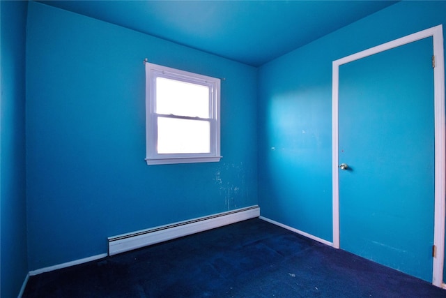 carpeted spare room with a baseboard radiator