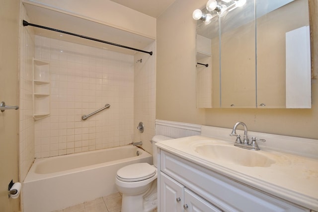 full bathroom with vanity, a wainscoted wall, shower / washtub combination, tile patterned floors, and toilet