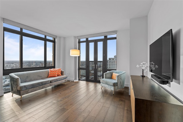 living room with expansive windows, baseboards, dark wood-type flooring, and french doors