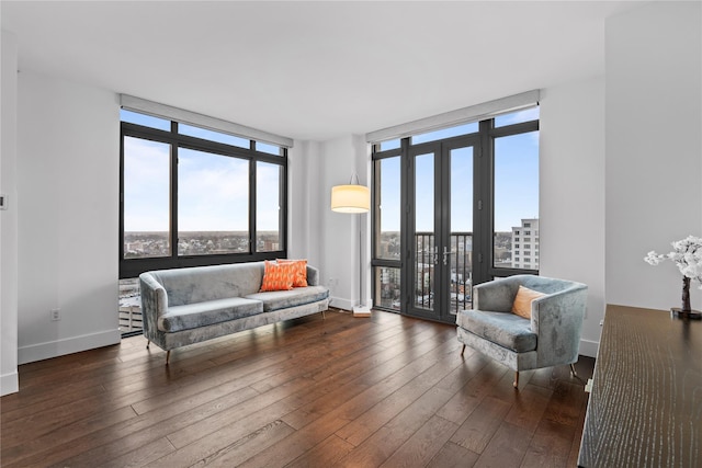 living area featuring hardwood / wood-style flooring, expansive windows, and french doors