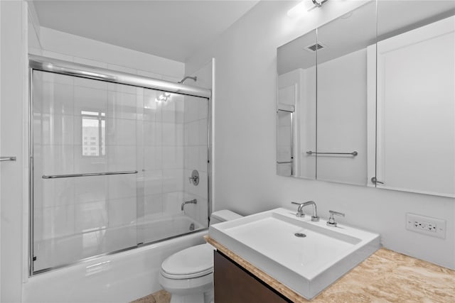 bathroom with visible vents, shower / bath combination with glass door, vanity, and toilet