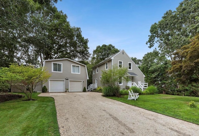 view of front of home featuring an attached garage, gravel driveway, and a front yard