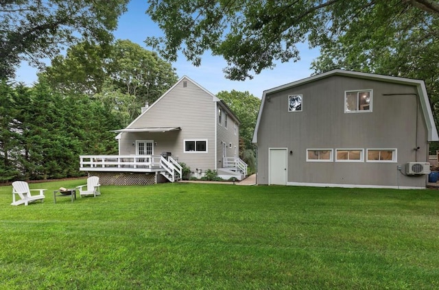 rear view of property with a yard and a wooden deck