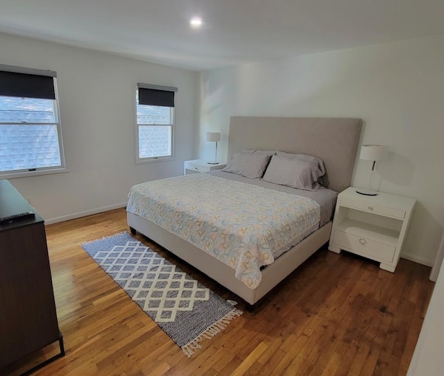 bedroom with wood finished floors and baseboards