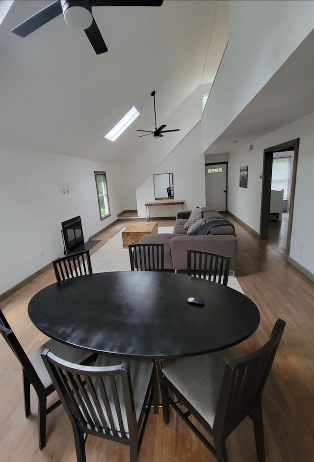 dining area with a skylight and wood finished floors