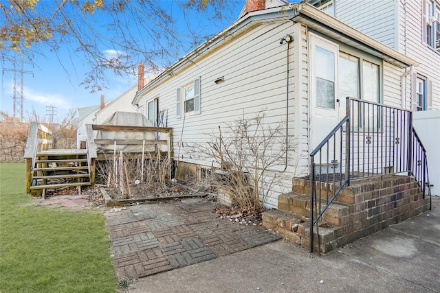 view of side of home featuring a yard and a chimney